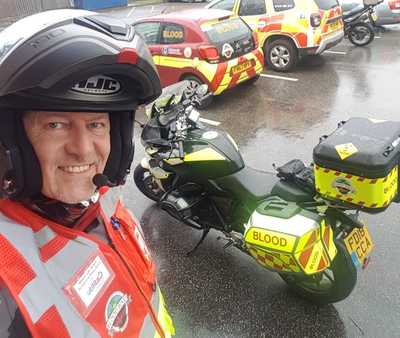 Volunteer Blood Biker stood by a Blood Bike