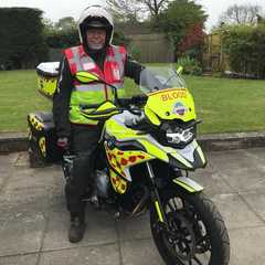 A volunteer sat on a blood bike